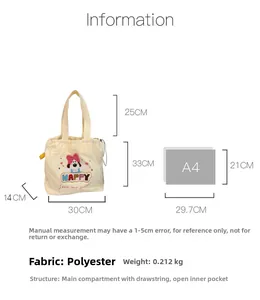 Detail view of cream canvas tote showing dog embroidery, drawstring, and size dimensions