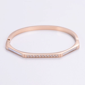 Macro view of rose gold stainless steel bracelet with shell inlay and cubic zirconia