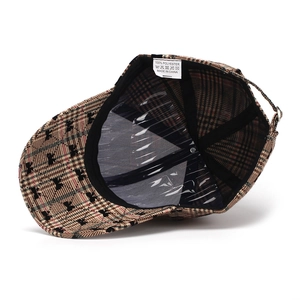 Detail view of the interior lining and bow print on this plaid polyester baseball cap