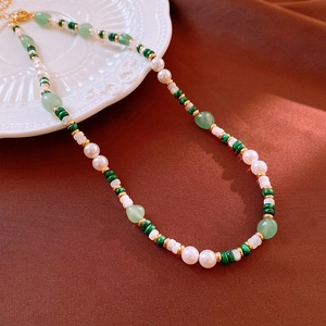 Detail of natural pearls and green malachite beads on a vintage gold chain