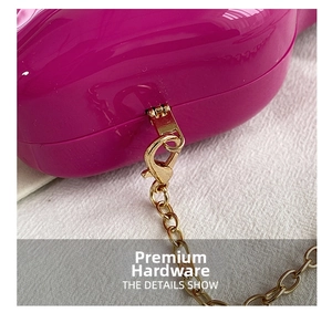 Detail of high-quality gold metal chain and lobster clasp on rose red box bag
