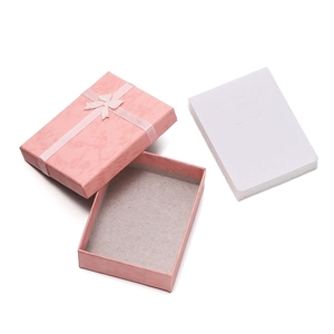 Detailed view of pink marble pattern jewelry box with elegant bow and sponge insert