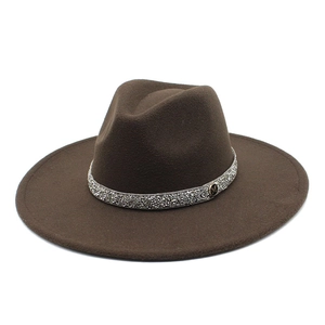 Close-up of wide brim fedora with silver rhinestone band and metallic M letter accent