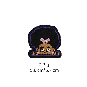 Detail view of cartoon girl embroidery patch with pink bow, size 5.6cm by 5.7cm