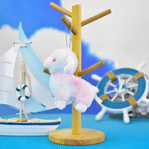 Detailed view of the colorful pink and blue gradient plush sheep keychain charm