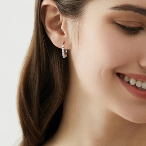Chic 925 sterling silver U-shaped moissanite hoop earrings worn by a female model