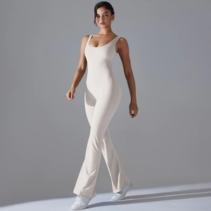 Detail of ivory yoga jumpsuit with flared pants showing fabric texture and slim fit design