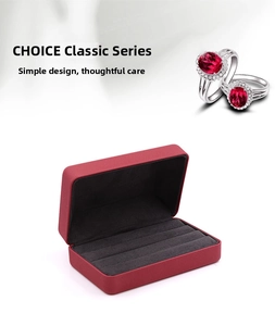 Macro detail of red jewelry box with grey velvet slots and elegant ruby rings