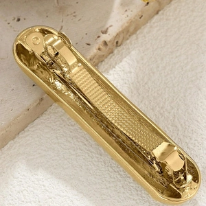 Polished gold alloy rectangular hair clip with anti-slip inner texture on stone
