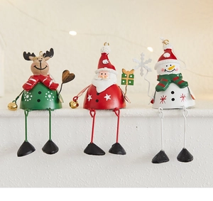 Detail of creative wrought iron Christmas ornaments with long metal dangling legs on a shelf