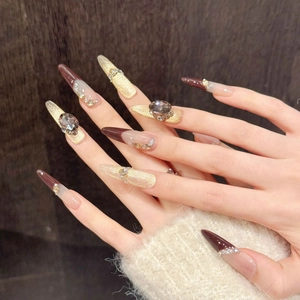 Detail view of handmade French cat-eye press-on nails with dark brown gems and pearls
