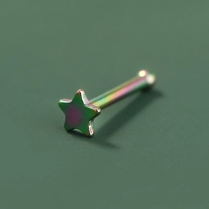 Macro shot of a rainbow-colored star piercing stud in polished stainless steel