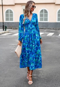 Detail of blue abstract print V-neck maxi dress with lace trim and tiered skirt design