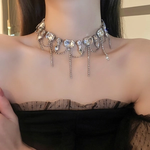 Close-up of sparkling rhinestone tassel necklace worn on a model with elegant silver finish