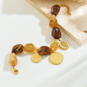 Vintage beaded bracelet with amber resin stones and gold St. Benedict medals on stone