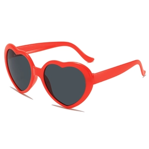 Red heart-shaped sunglasses with dark grey lenses shown from a 3/4 side angle view