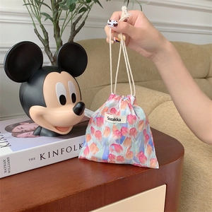 Detail of floral drawstring pouch showing tulip print and cotton rope handle