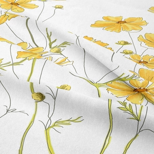 Detailed macro shot showing watercolor yellow daisy print on soft cotton linen fabric