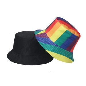 Detail view of rainbow striped and black bucket hats showing durable canvas and brim stitching