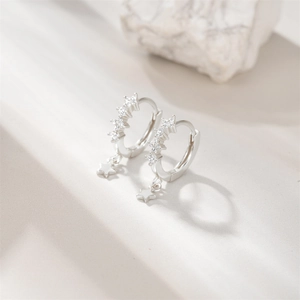 Detail of S925 sterling silver hoop earrings with clear stones and star pendants