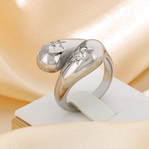Macro detail of silver stainless steel ring with teardrop rhinestones and star engraving