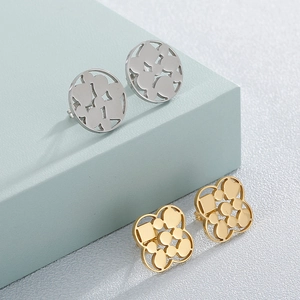 Polished silver circle and golden clover hollow stud earrings on blue geometric props