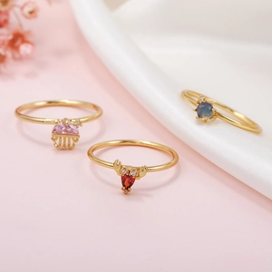 Three 18K gold rings with pink, red and blue zircon featuring cute sea animal designs