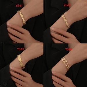 Detailed comparison of four gold titanium bracelets in feather and leaf designs