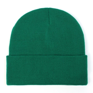 Close-up of fine green knit texture and thick ribbed cuff on a winter beanie hat