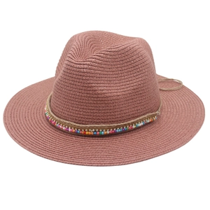 Close-up of bohemian dusty pink straw hat with colorful beads and rhinestone trim detail