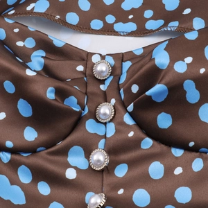 Elegant vintage brown polka dot satin dress featuring bubble sleeves and pearl buttons