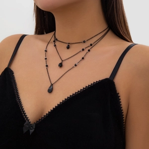 Macro shot of tiered gothic necklace with black beads and teardrop pendants for women