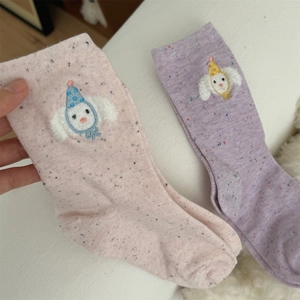 Close-up of cute cartoon bear embroidery on pink and purple speckled cotton socks