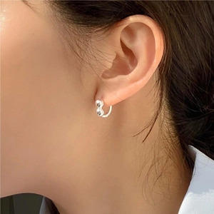 Minimalist 925 sterling silver hoop earrings with liquid metal design on model