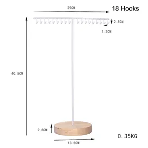 Minimalist T-bar iron jewelry rack with 18 hooks and a round wooden base for necklaces