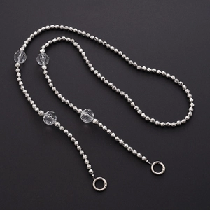 Detail of silver beaded crossbody chain with clear acrylic charms and round spring clasps