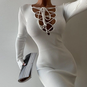Sleek white long-sleeve knit dress featuring a criss-cross front tie and slimming fit