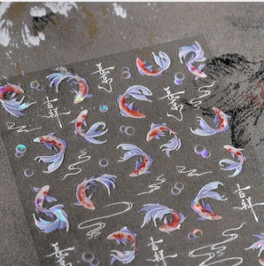 Detail view of iridescent koi fish nail stickers with Chinese calligraphy and bubbles