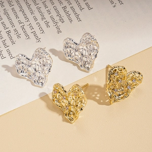 Lava texture heart-shaped hollow earrings with zircons in gold and silver finishes