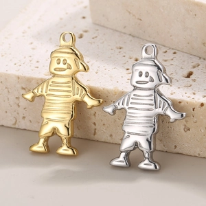 Detail of hip hop style boy and girl pendant charms in gold and silver stainless steel