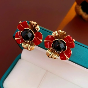 Vintage flower earrings with red enamel petals and black center gemstone in a gift box