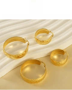 Detail of 18K gold plated stainless steel hoop earrings with honeycomb hammered texture