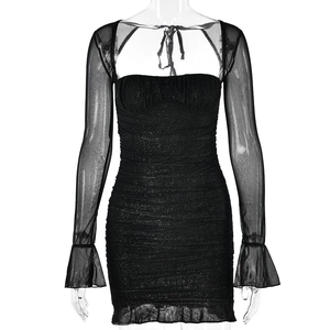 Close-up of black sequined bodycon mini dress with sheer mesh bell sleeves and ruched texture