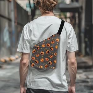 Detail of grey Halloween chest bag with orange pumpkin prints worn by a model in the street