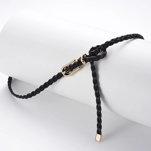 Slim black woven PU belt with gold metal buckle for dresses, studio product photography