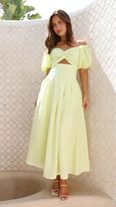 Detail of light yellow puff sleeve crop top and high waist ruched midi skirt set