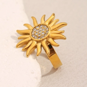 Detailed macro view of an 18K gold-plated sunburst ring with sparkling zircon stones