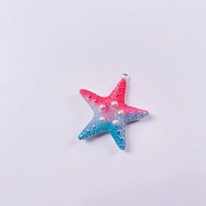 Macro detail of gradient resin starfish pendant with pearly texture and hanging ring