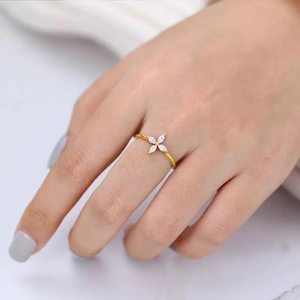 Detailed view of gold plated leaf ring featuring marquise cut white crystal petals