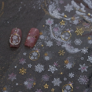 Christmas nail stickers with gold embossed snowflakes and stars on matte pink nails